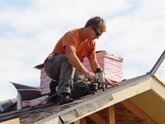Roofer fixing a roof