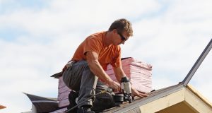 Roofer fixing a roof