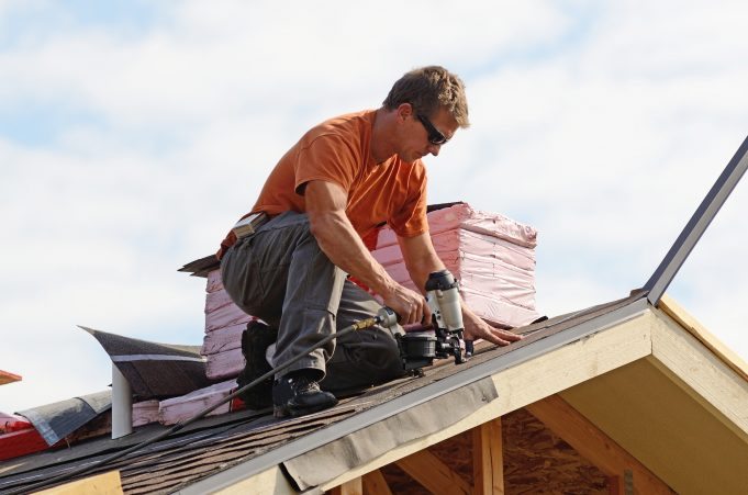 Roofer fixing a roof